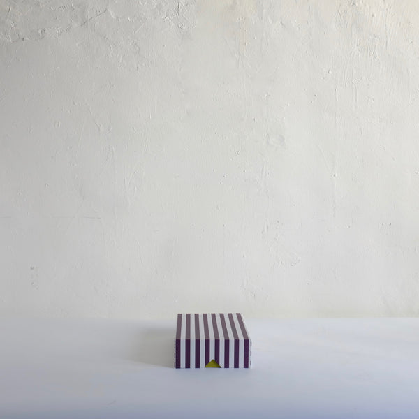 Black striped box with green base