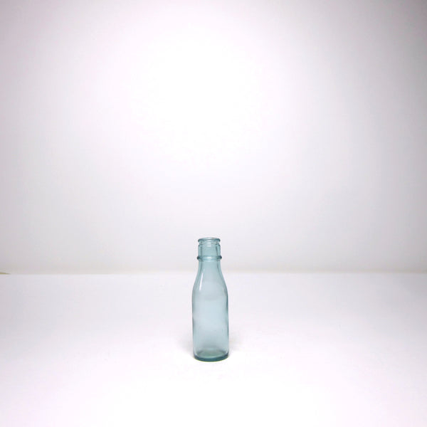 Small blue glass milk bottle