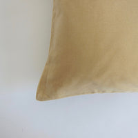 Pale yellow velvet cushion