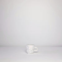 White carved mug