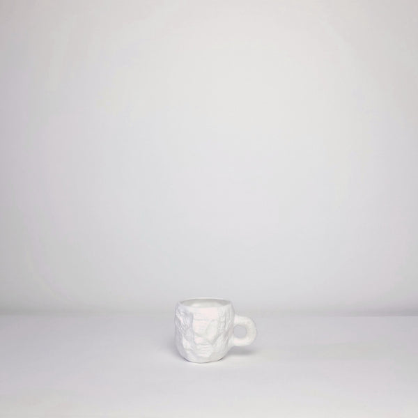 White carved mug
