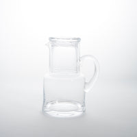 Clear glass carafe and glass
