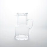 Clear glass carafe and glass