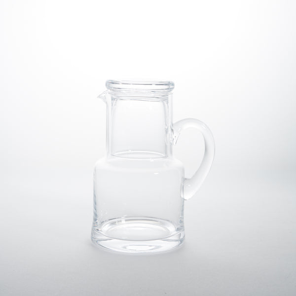 Clear glass carafe and glass