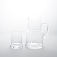 Clear glass carafe and glass