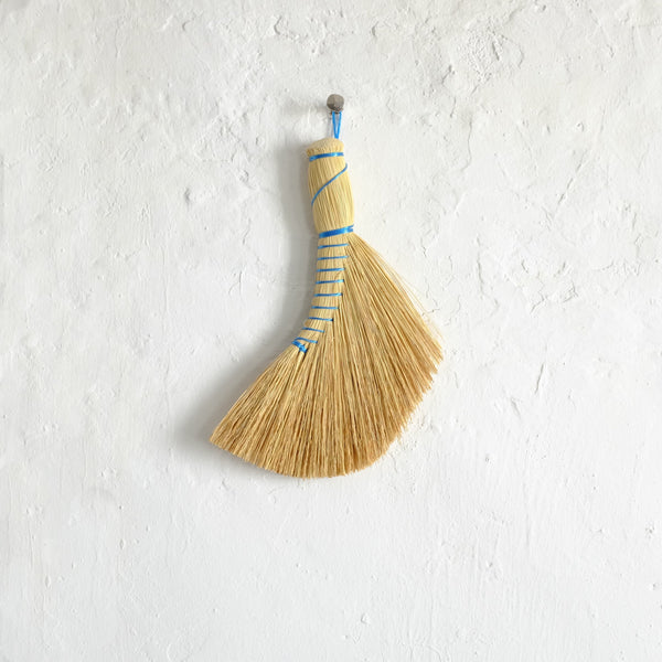 Curved hand broom with blue thread
