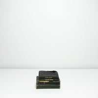 Four small vintage black books