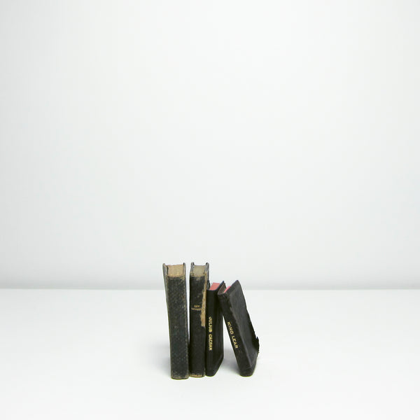 Four small vintage black books