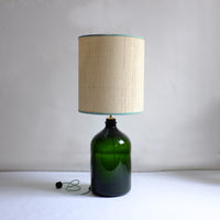 Large green glass lamp with raffia shade