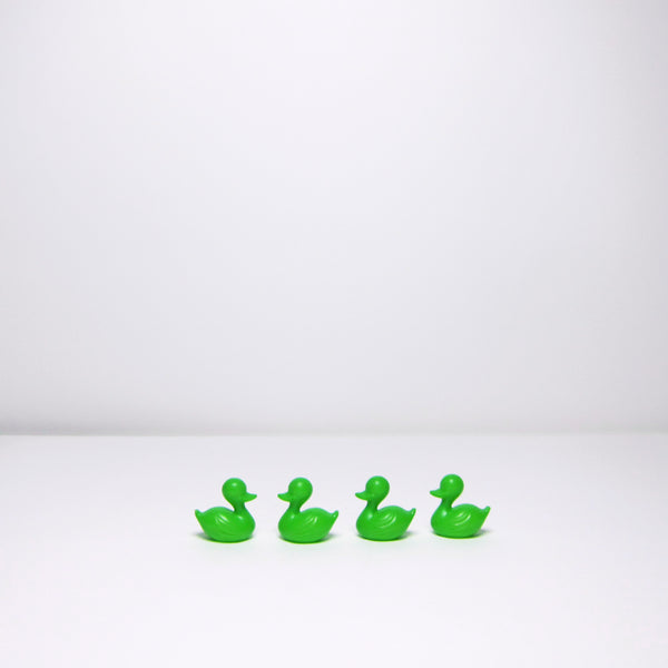 Four green plastic ducks