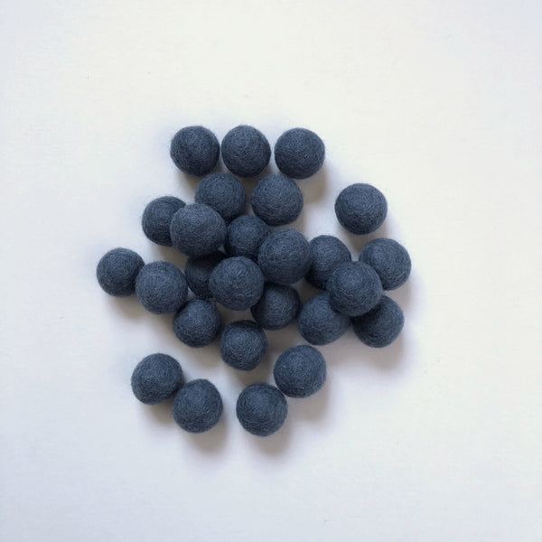 Thirty charcoal felt balls
