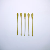 Thin carved wood spoon