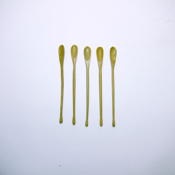 Thin carved wood spoon