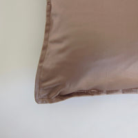 Muted pink satin cushion