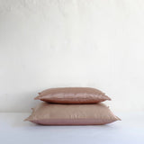 Muted pink satin cushion