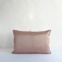 Muted pink satin cushion