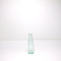 Green glass milk bottle