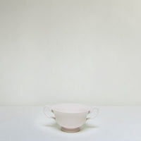 Painted ceramic bowl with handle.