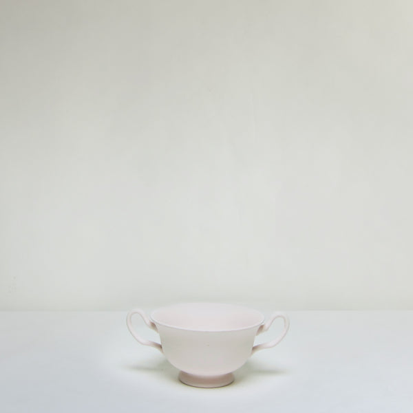 Painted ceramic bowl with handle.