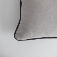 Pale grey piped cushion