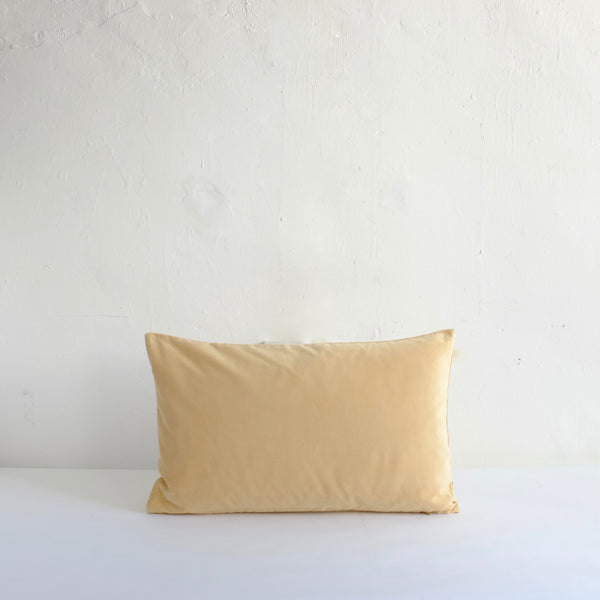 Pale yellow velvet cushion