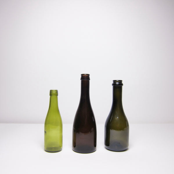 Set of three green glass bottles