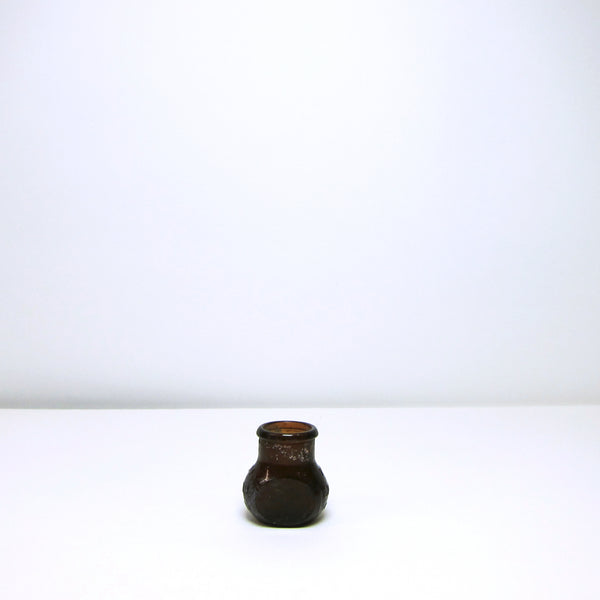 Small brown glass jar