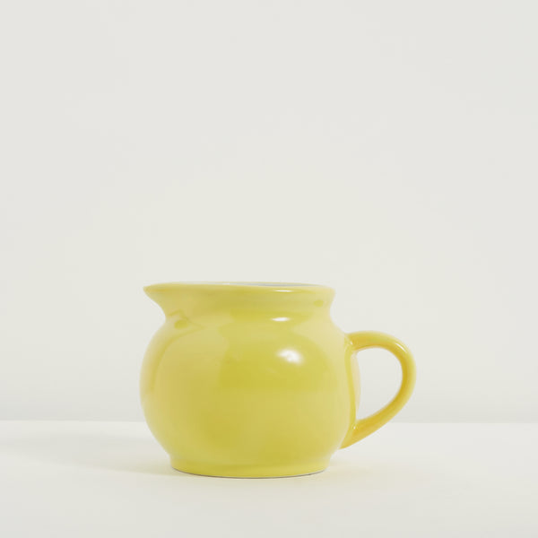 Small bright yellow ceramic jug