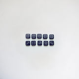 Ten black bakelite dice