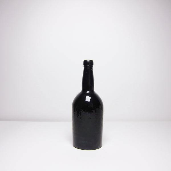 Vintage black glass bottle