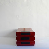 Vintage red stackable archive boxes.