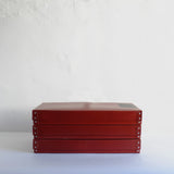 Vintage red stackable archive boxes.
