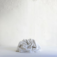 White cotton cable knit blanket