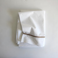White double sheet with taupe trim