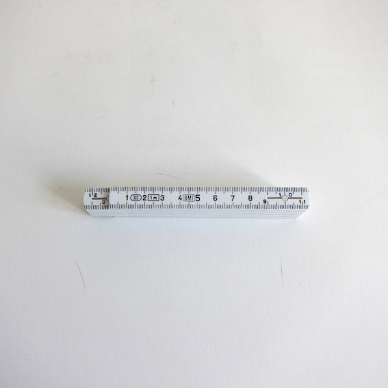 Small white folding ruler