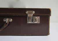 Thin brown leather suitcase