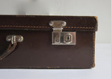 Thin brown leather suitcase