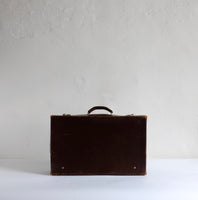 Thin brown leather suitcase