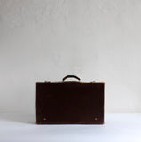 Thin brown leather suitcase