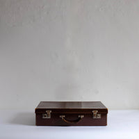 Thin brown leather suitcase