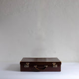 Thin brown leather suitcase